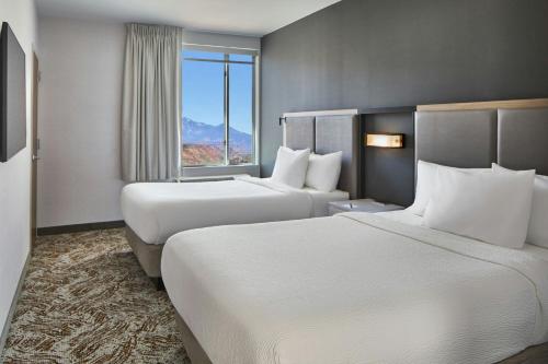 a hotel room with two beds and a window at SpringHill Suites by Marriott Moab in Moab
