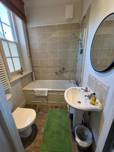 a bathroom with a sink and a tub and a toilet at Apartment No.1 in Lincoln