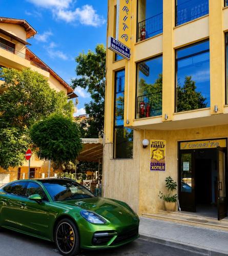 a green car parked in front of a building at Хотел ЗОНАРИТА in Primorsko