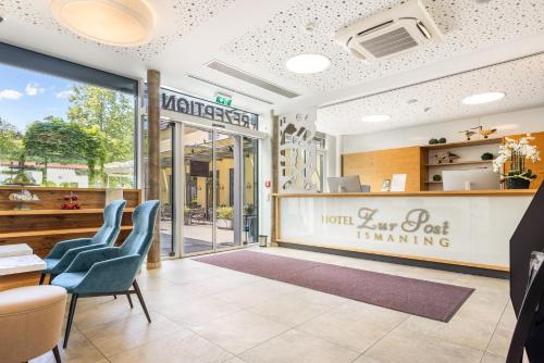 a restaurant with blue chairs and a sign that reads hotel servoit winning at Hotel Zur Post in Ismaning