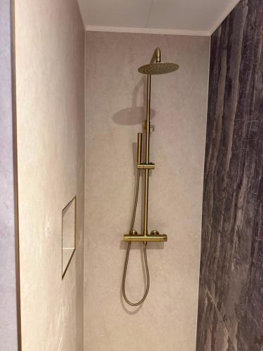 a bathroom with a hanging showerachi on the wall at Amadeus Hotel in Haarlem