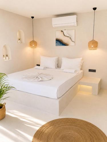 a white bedroom with a large white bed at Doc's Boutique Hotel Kemer in Kemer