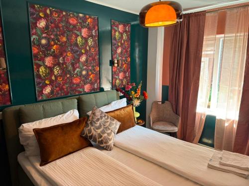 a bedroom with a bed and a painting on the wall at Amadeus Hotel in Haarlem