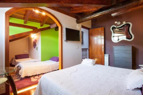 a bedroom with two beds and a green wall at Aberasturi in Gautegiz Arteaga