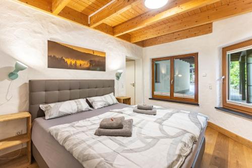 a bedroom with a large bed with two pillows on it at Ferienhaus Rothaarblick mit Sauna in Schmallenberg
