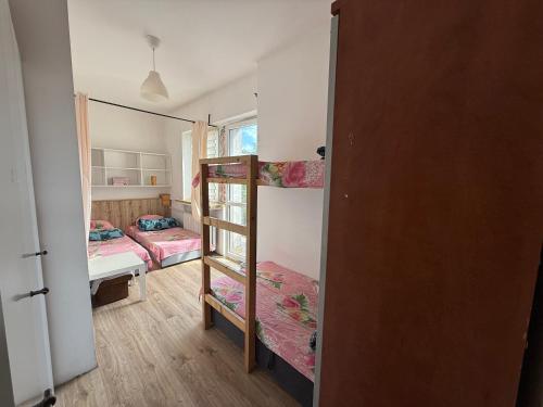a small room with two bunk beds and a bedroom at Century hostel in Gdynia