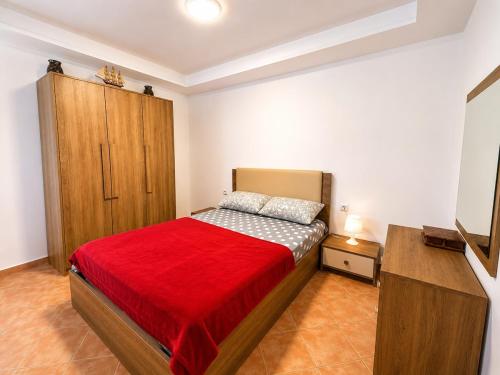 a bedroom with a bed and a wooden cabinet at House Soleil in Agadir nʼ Aït Sa