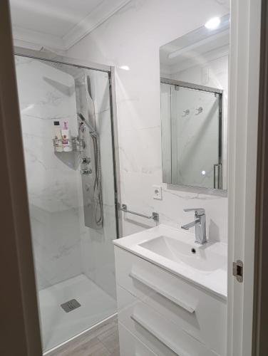 a white bathroom with a sink and a shower at SUNSHINE GROUP in Málaga