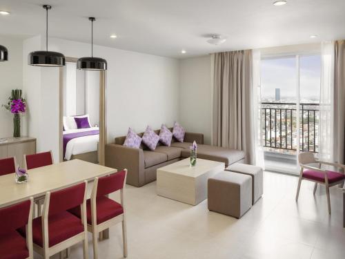 a living room with a couch and a table at Mercure Hai Phong in Hai Phong