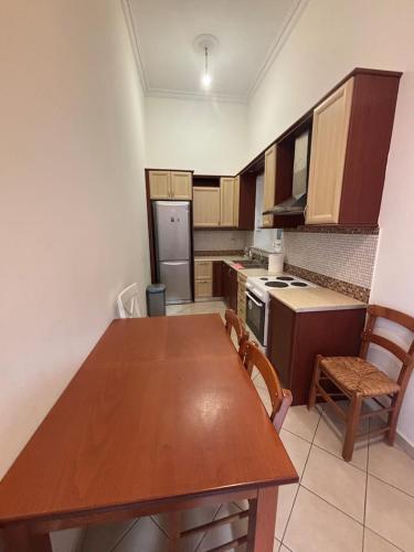 a kitchen with a wooden table and chairs in it at The Old Winery in Aliveri