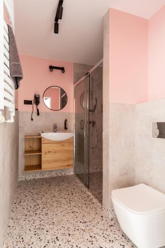 a bathroom with a toilet sink and a shower at New Adler Bed & Breakfast in Łódź