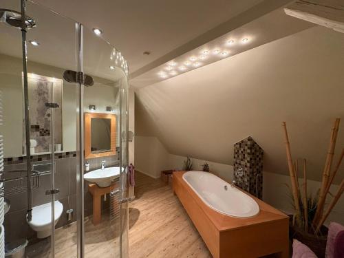 a bathroom with a tub and a sink and a shower at Fachwerkliebe Baudenkmal Ornes in Olsberg