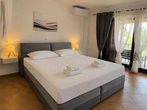 a bedroom with a bed with two towels on it at Apartments Bernarda 1 in Nin