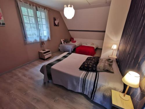a bedroom with two beds and a window at Chambres - La Chenevelle in Chitenay