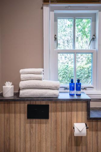 a bathroom with a counter with towels and a window at The Kilchrenan Inn in Oban