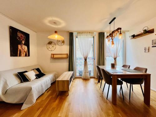 a living room with a couch and a table at Modern 1-Bedroom Retreat in Lausanne