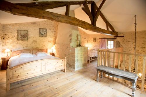 a bedroom with a large wooden bed in a room at GITE FOUR A PAIN 4 pers in Bon-Encontre