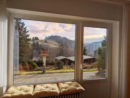 a large window with a couch in a living room at Haus Kiel Wohnung Mühlenberg in Altenau