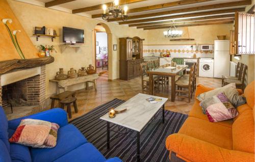 a living room with a blue couch and a table at Matasiete in Laroya
