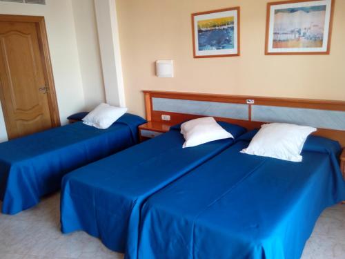 Postel nebo postele na pokoji v ubytování Hostal Leo d'Or