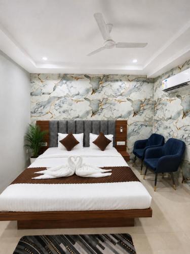 a bedroom with a bed with two white towels at hotel glory in Haridwār