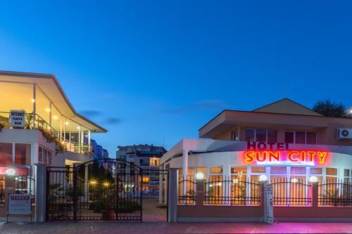 a hotel with a sign that reads hotel sun city at Sun City Hotel in Sunny Beach