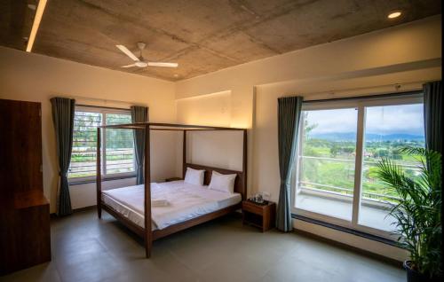 a bedroom with a bunk bed and a large window at Evara Sky Jacuzzi Villa in Igatpuri