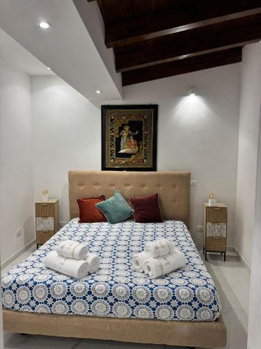 a bedroom with a bed with towels on it at Anastasia's House in Palermo