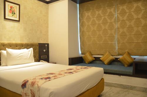 a hotel room with a bed and a window at Dee Empresa Hotel in Kolkata