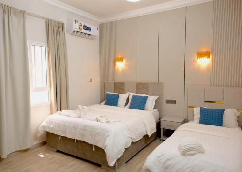a hotel room with two beds and a mirror at Sea Turtles Guest House in Al Ḩadd