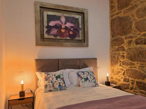 a bedroom with a bed with flowers on it at Monção Golden I I in Monção