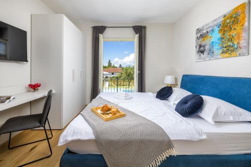 a bedroom with a bed with a desk and a window at Villa Bartol in Trviž