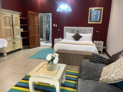a living room with two beds and a couch at Muco Guest House in Johannesburg