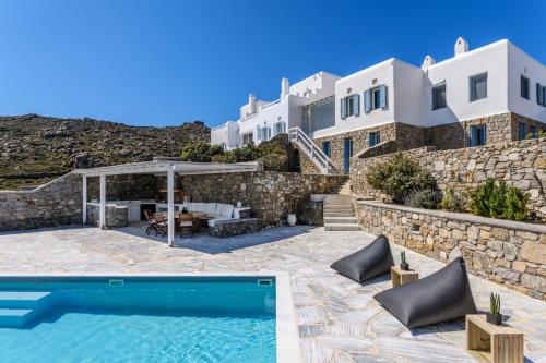 a villa with a swimming pool and a house at Lunar Villa in Glastros