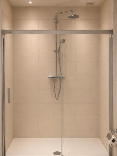 a shower with a glass door in a bathroom at Downtown Velvet Loft in Brussels