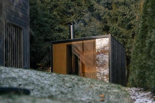 a wooden building with a pipe on top of a hill at Casa Calma in Čenkovice