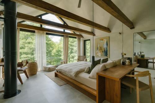 a bedroom with a large bed and a desk at Casa Calma in Čenkovice