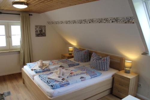 a bedroom with a bed with blue and white pillows at Appartment Vermietung Lütje in Büsum