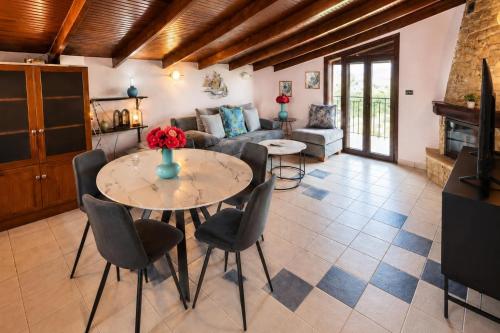 a living room with a table and chairs and a couch at Aliston Hotel Thassos in Skala Potamias