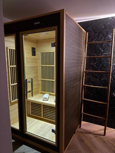 a walk in shower with a glass door in a room at Le fruit défendu 67 in Brumath