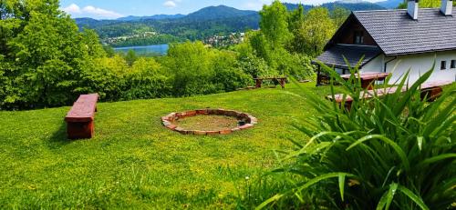 a park with a bench and a fire pit in the grass at Dom u Braci in Wołkowyja