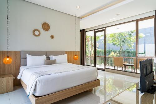 a bedroom with a large bed and a balcony at Oyama City View Villa 4 Bedrooms With a Private Heated Swimming Pool and a Billiard Table in Bandung