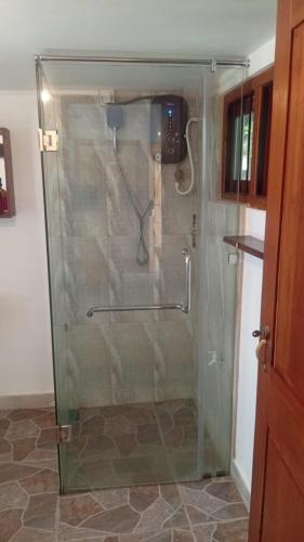 a shower with a glass door in a bathroom at Bella Nilaveli Beach in Nilaveli