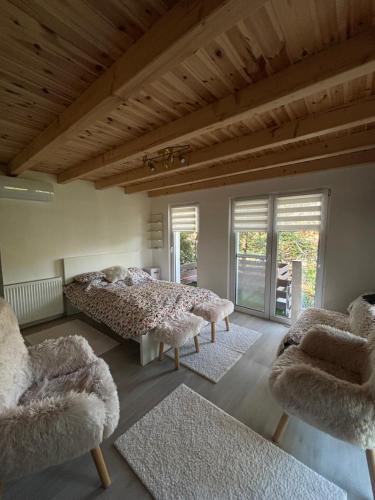a bedroom with two beds and two chairs at Pop Apartment Kerepes in Kerepes