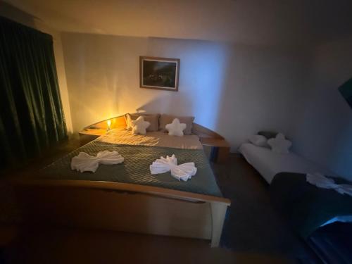 a bedroom with two beds with towels on them at Cabana GRAD in Săliştea de Sus