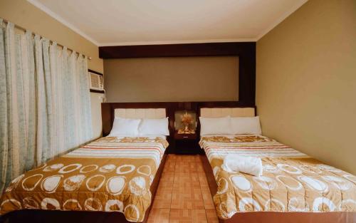 two beds in a hotel room at Grotto Vista Resort in San Jose del Monte