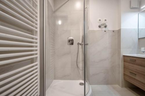 a shower with a glass door in a bathroom at Feriendomizil Putbus - Nr. 3c in Putbus