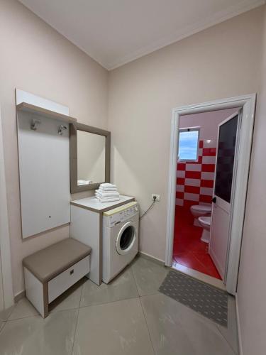 a bathroom with a washing machine and a toilet at MEGA Apartments in Fushë-Draç