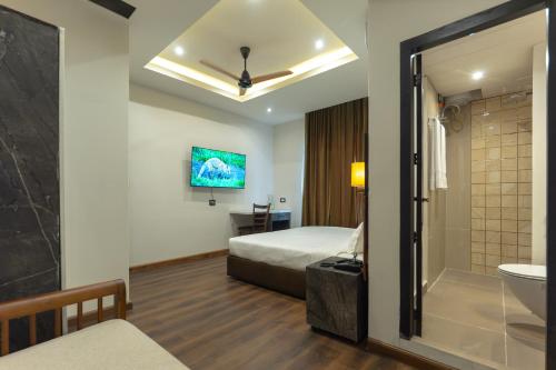 a hotel room with a bed and a bathroom at Grand Hotel Annex in Āīzawl