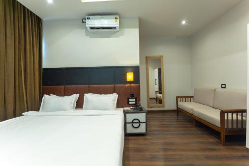 a hotel room with a bed and a couch at Grand Hotel Annex in Āīzawl